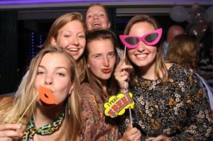 Gasten poseren voor de fotospiegel op een feest