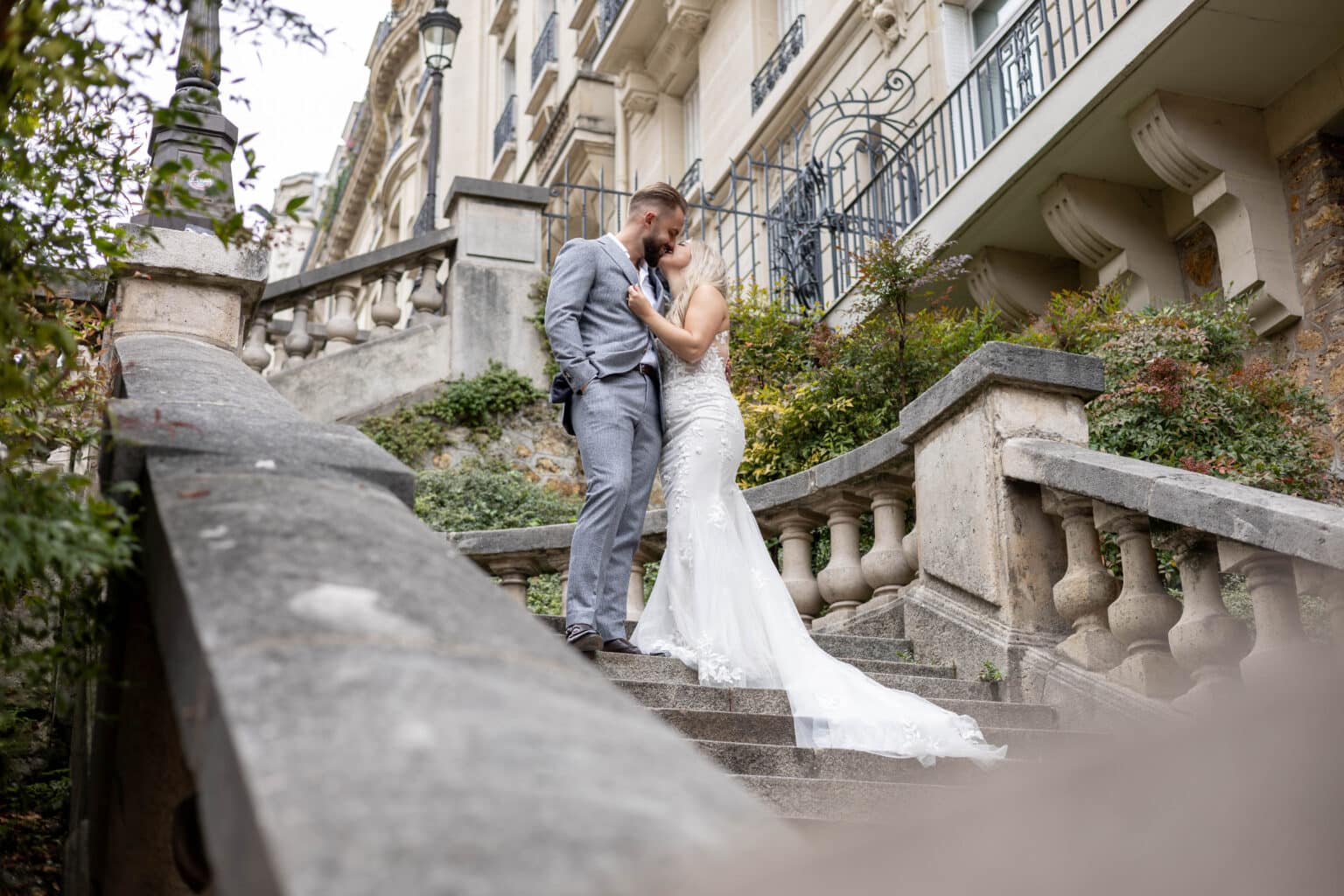 Bruidskoppel op een trap in parijs.